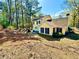 The backyard features a yellow home with a patio and plenty of room for activities at 4722 Bradford Ln, Powder Springs, GA 30127