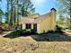 View of home's yellow siding, mature trees, a screened porch and spacious backyard area at 4722 Bradford Ln, Powder Springs, GA 30127