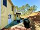 This home features a nice backyard with double doors, patio, grill, and lush landscaping at 4722 Bradford Ln, Powder Springs, GA 30127