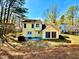 The backyard showcases a yellow home with a patio and grill at 4722 Bradford Ln, Powder Springs, GA 30127