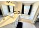 Bathroom featuring large vanity with dual sinks and corner tub at 4722 Bradford Ln, Powder Springs, GA 30127