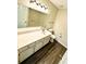 Bathroom featuring a vanity with sink, toilet, and shower with tile surround at 4722 Bradford Ln, Powder Springs, GA 30127