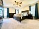 Bright bedroom with windows, ceiling fan, and dark wood furniture at 4722 Bradford Ln, Powder Springs, GA 30127