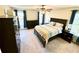 Comfortable bedroom with great natural light, ceiling fan and dark furniture at 4722 Bradford Ln, Powder Springs, GA 30127