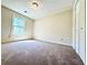 Bedroom with a window and closet, featuring carpeted floors and neutral walls at 4722 Bradford Ln, Powder Springs, GA 30127