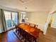 Formal dining room with dark wood floors, traditional furniture, wainscotting, and large bright windows at 4722 Bradford Ln, Powder Springs, GA 30127