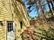 Side view of a home with yellow siding, windows, and a white entry door with a path at 4722 Bradford Ln, Powder Springs, GA 30127