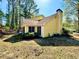 Back view of a yellow home featuring a chimney, a screened porch, and manicured landscaping at 4722 Bradford Ln, Powder Springs, GA 30127