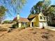 Charming two-story home with a two-car garage and well-maintained lawn and mature trees at 4722 Bradford Ln, Powder Springs, GA 30127