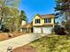 Charming two-story home with a two-car garage, green lawn, and fire hydrant in view at 4722 Bradford Ln, Powder Springs, GA 30127
