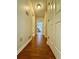 Hallway with wood tile floor and white doors at 4722 Bradford Ln, Powder Springs, GA 30127