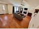 Spacious living room featuring vaulted ceilings, wood floors, and a cozy fireplace with a TV above at 4722 Bradford Ln, Powder Springs, GA 30127