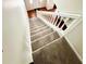 Carpeted staircase leading to the entry door with white railing at 4722 Bradford Ln, Powder Springs, GA 30127