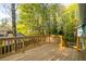 Inviting wood deck with railing, surrounded by lush greenery, providing a peaceful outdoor retreat at 5030 Sumit Wood Dr, Kennesaw, GA 30152