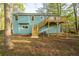 Large backyard with multi-level deck and mature trees, perfect for entertaining at 5030 Sumit Wood Dr, Kennesaw, GA 30152