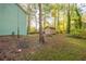 Backyard with a small shed, grass, and a swing set, perfect for outdoor enjoyment at 5030 Sumit Wood Dr, Kennesaw, GA 30152