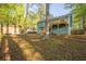 Spacious backyard with lush trees, a storage shed, and a multi-level deck, perfect for outdoor entertaining at 5030 Sumit Wood Dr, Kennesaw, GA 30152