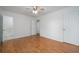 Bedroom features hardwood floors, white walls, a ceiling fan, and ensuite bathroom at 5030 Sumit Wood Dr, Kennesaw, GA 30152
