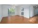 Open dining area with hardwood floors, white walls, a sliding glass door, and view to the kitchen at 5030 Sumit Wood Dr, Kennesaw, GA 30152