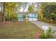 Two-story home with light blue siding, a two-car garage, a well-manicured lawn, and a clear house number at 5030 Sumit Wood Dr, Kennesaw, GA 30152