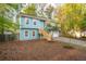 Inviting home featuring a light blue exterior, a front yard with stairs leading to the entrance and a long driveway at 5030 Sumit Wood Dr, Kennesaw, GA 30152
