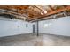 Unfinished garage with a window, access door, and bare ceiling with visible pipes at 5030 Sumit Wood Dr, Kennesaw, GA 30152