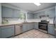 Functional kitchen with blue cabinets, stainless steel appliances, a tile backsplash, and tile floors at 5030 Sumit Wood Dr, Kennesaw, GA 30152