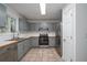 Kitchen with gray cabinets, stainless steel appliances, tile floors, and good natural light at 5030 Sumit Wood Dr, Kennesaw, GA 30152