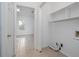 Bright laundry room with tiled floor, white walls, and convenient shelving for storage solutions at 5030 Sumit Wood Dr, Kennesaw, GA 30152