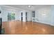 Spacious living room featuring hardwood floors, a ceiling fan, white walls, and large sliding glass doors at 5030 Sumit Wood Dr, Kennesaw, GA 30152