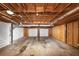 Unfinished basement space, offering potential for customization with exposed wooden ceiling and access to garage doors at 5848 Dunn Sw Rd, Mableton, GA 30126