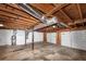 Unfinished basement features stairs, water heater, two garage doors and wooden ceiling beams, ready to be finished at 5848 Dunn Sw Rd, Mableton, GA 30126