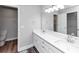 Bathroom with double sink vanity, large mirror, and tile floors at 5848 Dunn Sw Rd, Mableton, GA 30126