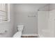 A bathroom features a toilet and white fiberglass shower at 5848 Dunn Sw Rd, Mableton, GA 30126