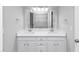A bathroom features a double sink vanity with a large mirror, and tile floors at 5848 Dunn Sw Rd, Mableton, GA 30126