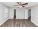 A bright empty bedroom features light walls, a closet, ceiling fan, and wood-look floors at 5848 Dunn Sw Rd, Mableton, GA 30126