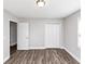 An empty bedroom features light walls, a closet, and wood-look floors at 5848 Dunn Sw Rd, Mableton, GA 30126
