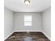 Empty bedroom with dark floors and a window at 5848 Dunn Sw Rd, Mableton, GA 30126