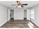 A bright empty bedroom features light walls, two closets, ceiling fan, and wood-look floors at 5848 Dunn Sw Rd, Mableton, GA 30126