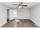 An empty bedroom features light walls, a ceiling fan, and wood-look floors at 5848 Dunn Sw Rd, Mableton, GA 30126
