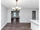 An open dining room features dark hardwood floors and a modern chandelier at 5848 Dunn Sw Rd, Mableton, GA 30126