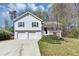 Charming two-story home featuring a two-car garage, front porch, and well-maintained landscaping at 5848 Dunn Sw Rd, Mableton, GA 30126