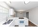 Bright eat-in kitchen includes bar seating, stainless steel appliances, and a view to the dining room at 5848 Dunn Sw Rd, Mableton, GA 30126