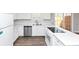 All-white kitchen with stainless steel dishwasher and view of sliding glass door at 5848 Dunn Sw Rd, Mableton, GA 30126