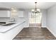 Eat-in kitchen boasts stylish light fixture and stainless steel appliances at 5848 Dunn Sw Rd, Mableton, GA 30126