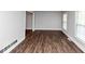 Bright, open living room with dark, hardwood flooring and a large window at 5848 Dunn Sw Rd, Mableton, GA 30126