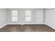Bright living room featuring modern vinyl floors, fresh paint, new trim, and natural light at 5848 Dunn Sw Rd, Mableton, GA 30126