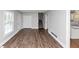 Open-concept living area with durable vinyl flooring, leading to stairs, kitchen, and hallway at 5848 Dunn Sw Rd, Mableton, GA 30126