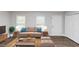 Cozy living room featuring modern vinyl floors and neutral decor at 5848 Dunn Sw Rd, Mableton, GA 30126