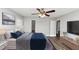 A staged main bedroom features light walls, a closet, ceiling fan, and wood-look floors at 5848 Dunn Sw Rd, Mableton, GA 30126